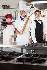 Image showing Confident Chefs And Waiter In Kitchen