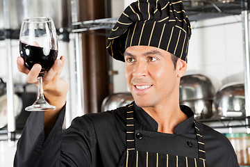 Image showing Chef Looking At Glass Of Red Wine