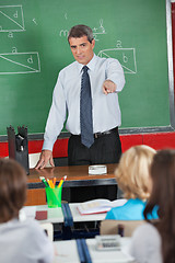 Image showing Mature Teacher Pointing At Students