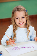 Image showing Girl Drawing At Desk In Kindergarten