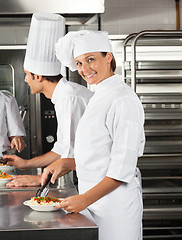 Image showing Female Chef Working In Restaurant Kitchen