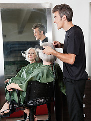 Image showing Hair Stylist Straightening Customer's Hair