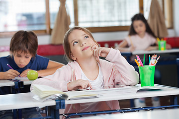 Image showing Schoolgirl With Digital Tablet At Desk Looking Up