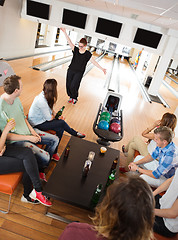 Image showing Friends Looking At Woman Dancing in Bowling Club