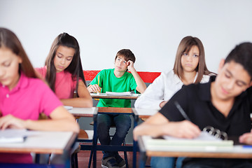 Image showing Thoughtful Schoolboy Studying In Classroom