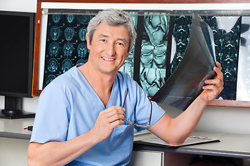 Image showing Happy Radiologist Holding X-ray