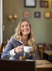 Image showing Happy Woman Drinking Coffee At Coffeeshop