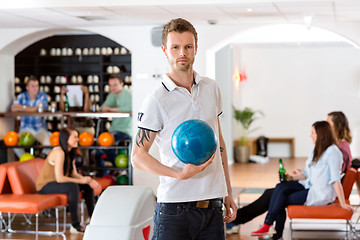 Image showing Confident Young Man With Bowling Ball in Club