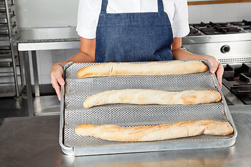 Image showing Female Chef Presenting Baked Loafs