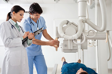 Image showing Radiologists Performing X-ray On Patient