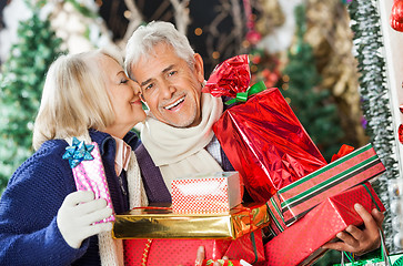 Image showing Woman About To Kiss Man Holding Presents