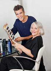 Image showing Hairstylist And Client With Color Catalog