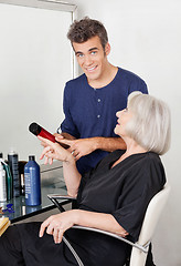 Image showing Hairdresser Showing Hair Product To Client