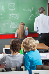 Image showing Little Schoolboys Using Digital Tablet At Desk