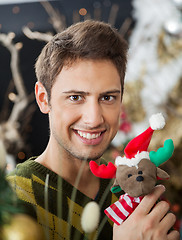 Image showing Man Holding Stuffed Toy In Christmas Store