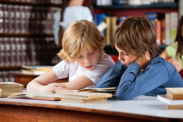 Image showing Little Boys Reading Book Together In Library