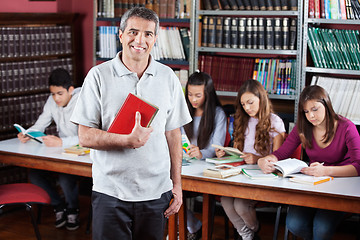 Image showing Male Librarian Standing In Library