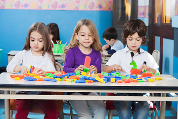 Image showing Children Playing With Construction Blocks In Classroom