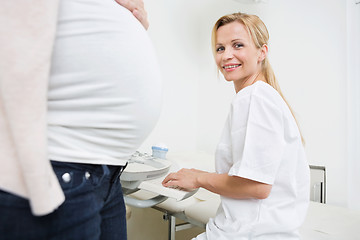 Image showing Happy Doctor Using Ultrasound Machine In Clinic