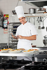 Image showing Happy Chef With Digital Tablet Checking List Of Pastas