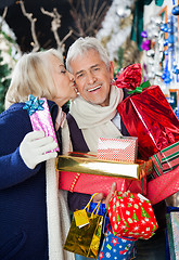 Image showing Woman Kissing Man At Christmas Store