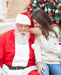 Image showing Girl Whispering Wish In Santa Claus's Ear