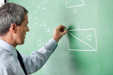 Image showing Male Professor Writing On Greenboard