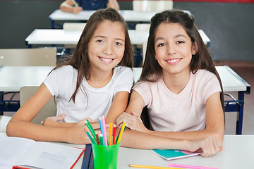 Image showing Schoolgirls Sitting At Desk In Classroom
