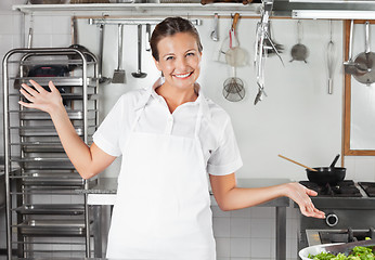 Image showing Female Chef Gesturing In Kitchen