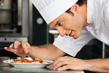 Image showing Male Chef Garnishing Dish
