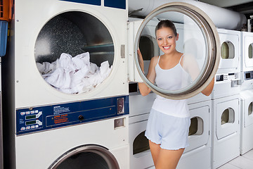 Image showing Woman Looking Through Washing Machine Lid