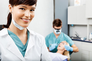 Image showing Female Hygienist With Dentist Working In The Background