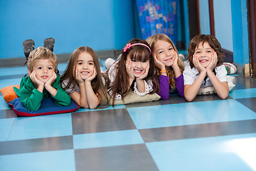 Image showing Children Lying In A Row On Floor