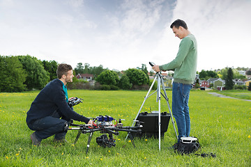 Image showing Engineers Working On UAV Helicopter in Park