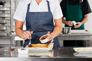 Image showing Chef Preparing Chocolate Roll