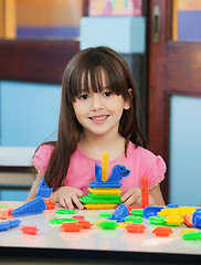 Image showing Little Girl With Construction Blocks In Classroom