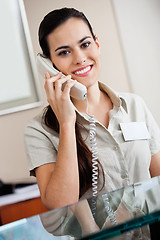 Image showing Female Receptionist Answering Call