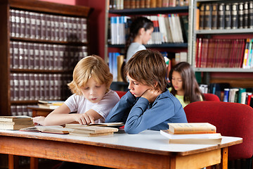 Image showing Schoolboys Reading Book Together In Library