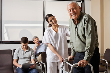 Image showing Nurse Helping Senior Patient With Walker