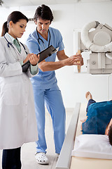 Image showing Radiologists With Patient In X-ray Room