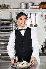 Image showing Waiter With Salmon Roll And White Wine