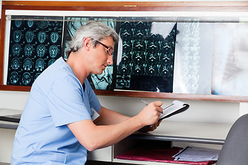 Image showing Doctor Writing On Clipboard