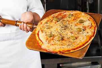 Image showing Chef Holding Pizza On Shovel