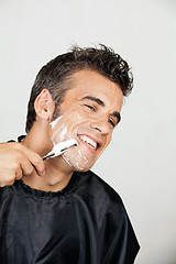 Image showing Happy Man Shaving His Face
