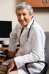 Image showing Male Doctor Sitting On Chair At Clinic