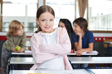 Image showing Little Girl Standing Arms Crossed At Desk