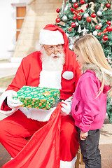 Image showing Santa Claus Giving Present To Girl