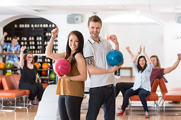 Image showing Excited Man And Woman With Bowling Balls in Club