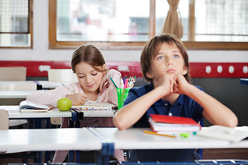 Image showing Schoolgirl Writing Notes In Classroom