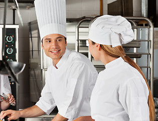 Image showing Male Chef With Colleague At Kitchen